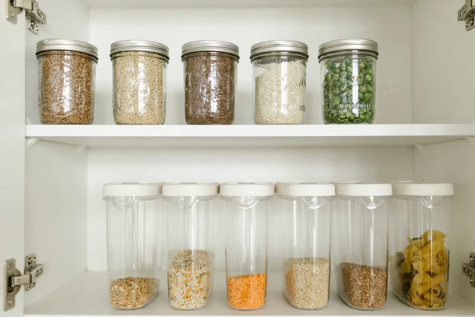 Photo of decanted dry goods in clear glass containers creating pantry storage